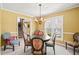 Cozy dining room with natural light, chandelier, and decorative chairs around a round table at 7109 River Birch Dr, Raleigh, NC 27613