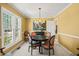 Bright dining room with big window, chandelier, and stylish chairs around a table at 7109 River Birch Dr, Raleigh, NC 27613