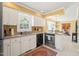 Bright kitchen featuring white cabinets, granite countertops, stainless steel appliances, and a window above the sink at 7109 River Birch Dr, Raleigh, NC 27613