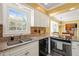 Well-lit kitchen boasts granite countertops, stainless steel appliances, and a view to the living room at 7109 River Birch Dr, Raleigh, NC 27613