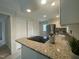 A well-lit kitchen with white cabinets, stainless steel appliances, and granite countertops at 7109 River Birch Dr, Raleigh, NC 27613