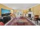 Spacious living room with a fireplace, TV, and classic furnishings, bathed in natural light at 7109 River Birch Dr, Raleigh, NC 27613