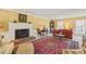 Bright living room features a fireplace, classic décor, and a vibrant area rug at 7109 River Birch Dr, Raleigh, NC 27613