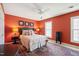 Bedroom features carpet, red walls, ceiling fan, and two windows providing natural light at 7109 River Birch Dr, Raleigh, NC 27613