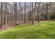 This backyard features a large grassy area and wooded acreage at 7212 Rabbit Run, Wake Forest, NC 27587
