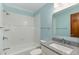 Bathroom featuring a tub with shower, granite counters and blue walls at 7212 Rabbit Run, Wake Forest, NC 27587