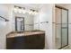Bathroom with granite counters, double sinks, and tile shower at 7212 Rabbit Run, Wake Forest, NC 27587