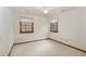 This bedroom features neutral carpet, trim detail, two windows and a ceiling fan at 7212 Rabbit Run, Wake Forest, NC 27587