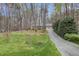This front yard features a large yard and a long driveway up to the house at 7212 Rabbit Run, Wake Forest, NC 27587