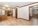 Open kitchen with wood cabinets, stainless steel appliances, granite countertops and hardwood floors at 7212 Rabbit Run, Wake Forest, NC 27587