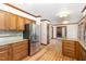 Open concept kitchen with hardwood floors, granite counters, wood cabinets and stainless appliances at 7212 Rabbit Run, Wake Forest, NC 27587