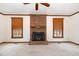 Open living room featuring a brick fireplace and natural light from two large windows at 7212 Rabbit Run, Wake Forest, NC 27587