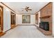Inviting living room featuring a cozy brick fireplace and views to other rooms of the house at 7212 Rabbit Run, Wake Forest, NC 27587