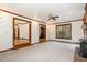 Spacious living room featuring a brick fireplace, a ceiling fan, and access to other rooms at 7212 Rabbit Run, Wake Forest, NC 27587