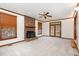 Bright living room with a brick fireplace, ceiling fan, and French doors to the exterior at 7212 Rabbit Run, Wake Forest, NC 27587