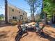 Expansive back yard with a patio dining set, mature trees, and string lights at 7301 Turtleneck Ct, Raleigh, NC 27616