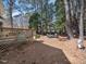 Lush back yard with patio dining, a grill, and mature trees, providing ample shade at 7301 Turtleneck Ct, Raleigh, NC 27616