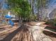 Scenic back yard featuring mature trees, a playground, and winding concrete paths at 7301 Turtleneck Ct, Raleigh, NC 27616