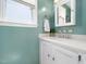 Bright bathroom with white vanity, silver faucet, and ample storage at 7301 Turtleneck Ct, Raleigh, NC 27616