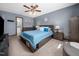 Spacious bedroom featuring contemporary decor, ceiling fan and en suite bathroom at 7301 Turtleneck Ct, Raleigh, NC 27616