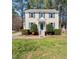 Charming two-story home featuring a well-manicured lawn and inviting curb appeal with blue shutters at 7301 Turtleneck Ct, Raleigh, NC 27616