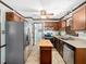 Bright kitchen with stainless steel appliances, wooden cabinets, and moveable kitchen island at 7301 Turtleneck Ct, Raleigh, NC 27616