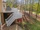 Multi-level back deck and staircase surrounded by lush greenery, offering a private outdoor space at 73214 Burrington, Chapel Hill, NC 27517