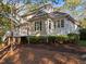 The backyard view features a multi-level deck, well-maintained landscaping, and a tranquil wooded backdrop at 73214 Burrington, Chapel Hill, NC 27517