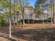 Expansive backyard featuring a multi-level deck, mature trees, and a serene setting for outdoor enjoyment at 73214 Burrington, Chapel Hill, NC 27517