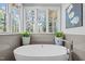 Close up on a soaking tub with modern fixtures and plants for a relaxing spa atmosphere at 73214 Burrington, Chapel Hill, NC 27517