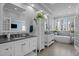 Luxurious primary bathroom featuring double vanities, soaking tub, and natural light at 73214 Burrington, Chapel Hill, NC 27517
