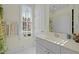 Bright bathroom with a vanity and mirror, plus a view from the window at 73214 Burrington, Chapel Hill, NC 27517