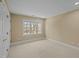 Neutral bedroom with plush carpet and a large window, perfect for relaxation at 73214 Burrington, Chapel Hill, NC 27517
