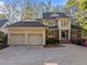 Charming home with a three-car garage, a brick and stucco facade, and lush landscaping in a desirable neighborhood at 73214 Burrington, Chapel Hill, NC 27517