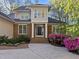 Elegant home featuring a brick facade, bright windows, and a welcoming front entrance with beautiful landscaping at 73214 Burrington, Chapel Hill, NC 27517