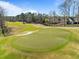 Aerial view of a green on the golf course with sand traps, trees, and blue sky at 73214 Burrington, Chapel Hill, NC 27517