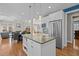 Spacious kitchen with large island, stainless steel appliances, and open dining area with a fireplace at 73214 Burrington, Chapel Hill, NC 27517