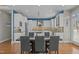 Open-concept kitchen and dining area featuring white cabinets, stainless steel appliances, and modern lighting at 73214 Burrington, Chapel Hill, NC 27517
