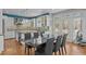 Modern kitchen and dining area with white cabinets, stainless appliances, and a large dining table at 73214 Burrington, Chapel Hill, NC 27517