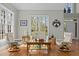 Bright living room with hardwood floors and large windows offers comfortable seating and ample natural light at 73214 Burrington, Chapel Hill, NC 27517