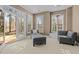 Living room with neutral decor, including a gray chaise and chair, and a view of the outdoors at 73214 Burrington, Chapel Hill, NC 27517
