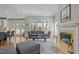 Comfortable living room features fireplace, gray sofa, and large windows for natural light at 73214 Burrington, Chapel Hill, NC 27517