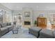 Cozy living room features a fireplace, plush seating, and windows offering outdoor views at 73214 Burrington, Chapel Hill, NC 27517