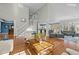 Open-concept living room boasts vaulted ceilings, hardwood floors, and staircase to the upper level at 73214 Burrington, Chapel Hill, NC 27517