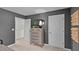 Cozy bedroom featuring a stylish dresser, mirror, neutral carpet, and gray walls at 7750 Michelle Rd, Rocky Mount, NC 27803