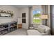 Cozy bedroom features an accent chair, natural light, and stylish shelving for decor at 7750 Michelle Rd, Rocky Mount, NC 27803