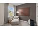 Relaxing bedroom offers a chaise lounge, contemporary art, and ample natural light at 7750 Michelle Rd, Rocky Mount, NC 27803