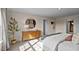Sunlit bedroom with a dresser, a large round mirror, and neutral tones at 7750 Michelle Rd, Rocky Mount, NC 27803