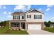 Charming two-story home featuring a brick and siding exterior with a two-car garage at 7750 Michelle Rd, Rocky Mount, NC 27803