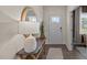 Bright entryway featuring a decorative table, mirror and luxury vinyl flooring at 7750 Michelle Rd, Rocky Mount, NC 27803